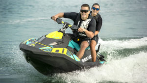 A MAN AND WOMAN IN SUNGLASSES ON A SEA-DOO